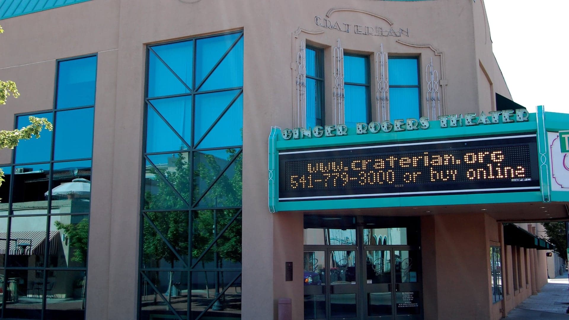 Exterior of the Ginger Rogers Theater, featuring a marquee with website and contact information.