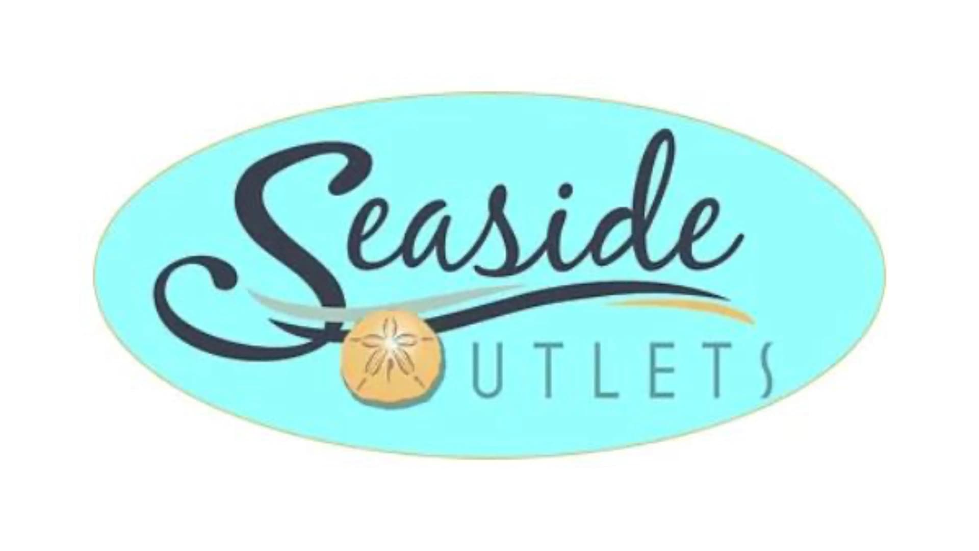 Logo for Seaside Outlets featuring stylized text on a light blue background with a sand dollar graphic.